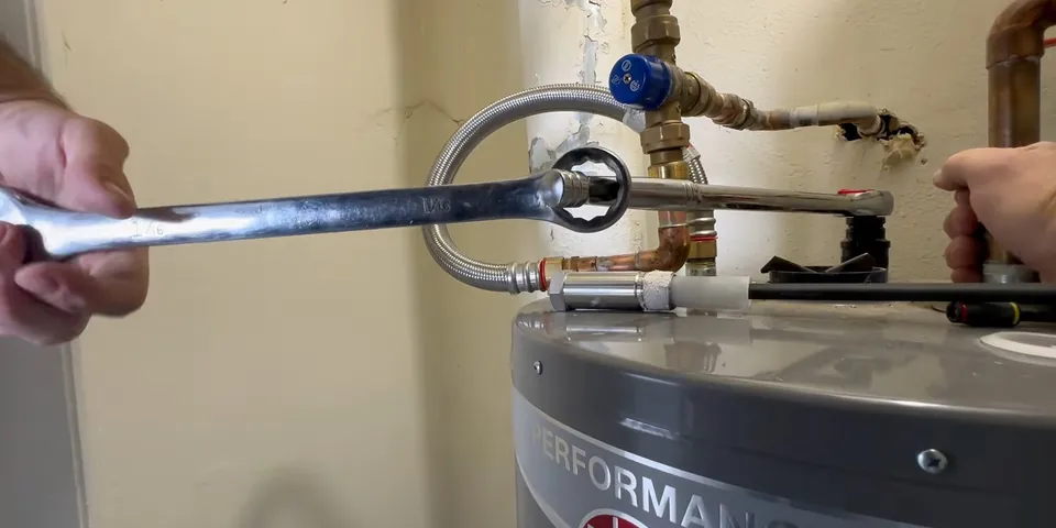 Anode rod being pulled from a water heater tank for Plumbing Service in the Lakewood Park Area, Lakewood CA