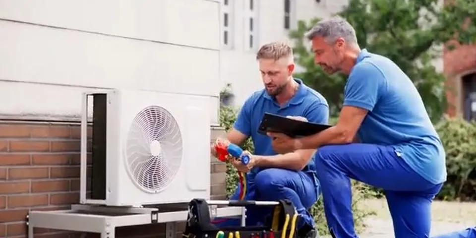 Contractors working outside beside residential equipment for Plumber in Cerritos, CA