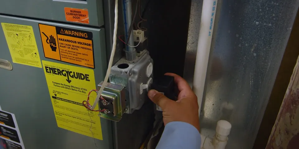 Gas water heater control valve being inspected for Gas Line Repair & Installation in Lakewood, CA