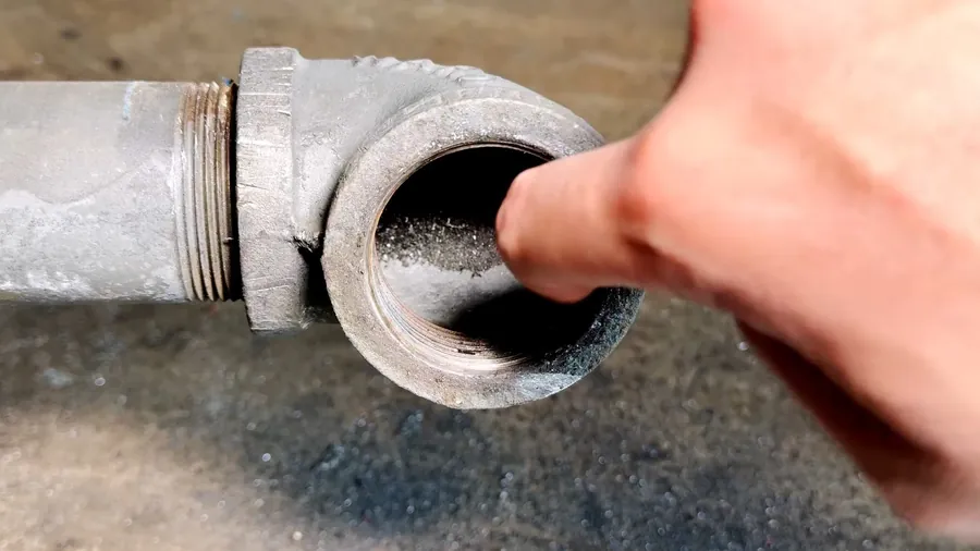 Hand checking the inside of a cleanout opening for Plumbing Service in the Mayfair District, Lakewood CA