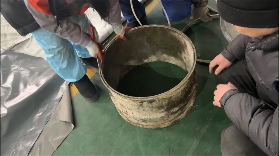 Hands removing debris from a drain cleaning bucket for Hydro Jetting in Lakewood, CA