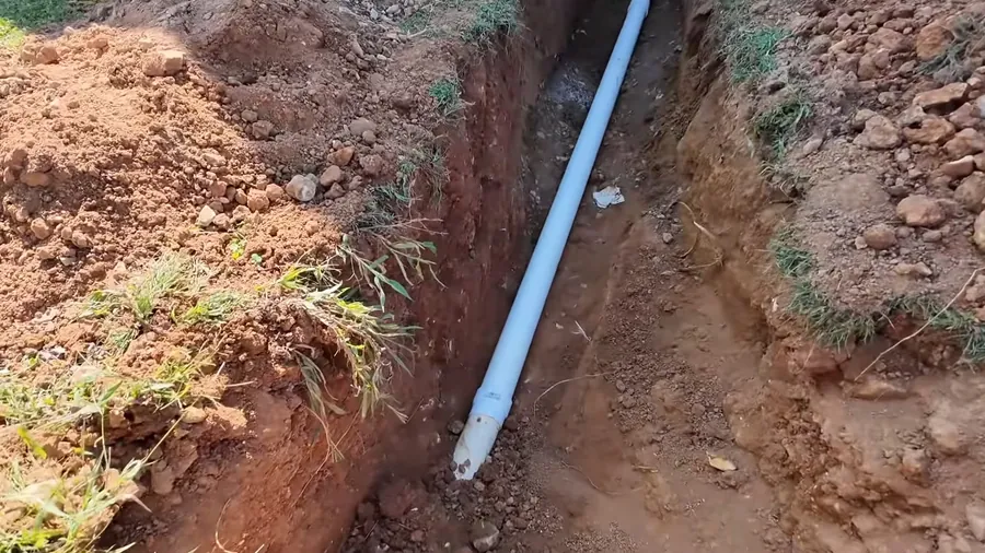 New white drain pipe laid inside an open trench for Sewer Line Replacement in Lakewood, CA
