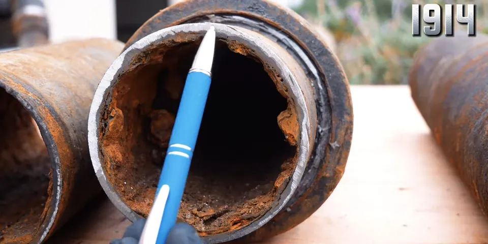 Old cast iron drain pipe with corrosion and scaling for Signs Your Galvanized Pipes Are Failing: A Lakewood Homeowner’s Guide