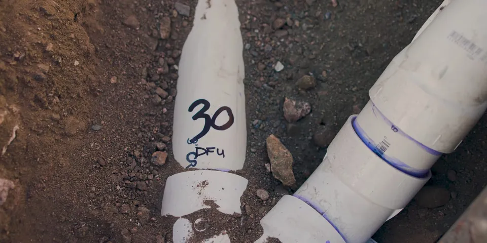 PVC drain pipe marked and buried below a slab for Plumber in Paramount, CA