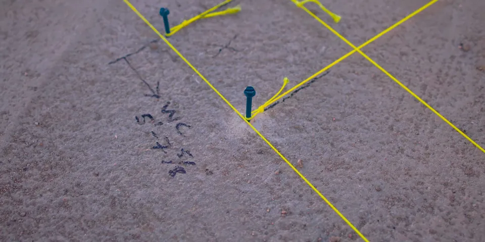 Slab floor marked with pipe routing lines for Why Slab Leaks Are So Common in Lakewood’s 1950s Slab-on-Grade Homes