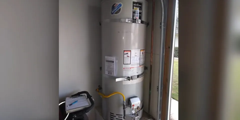 Tall water heater with service tag in a closet for Water Heater Installation & Replacement in Lakewood, CA