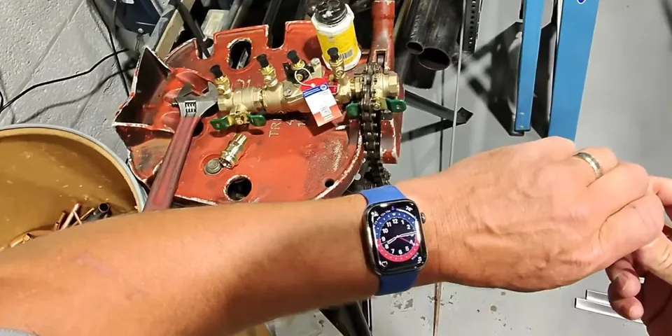 Technician testing a backflow preventer with gauges attached for Backflow Testing & Prevention in Lakewood, CA
