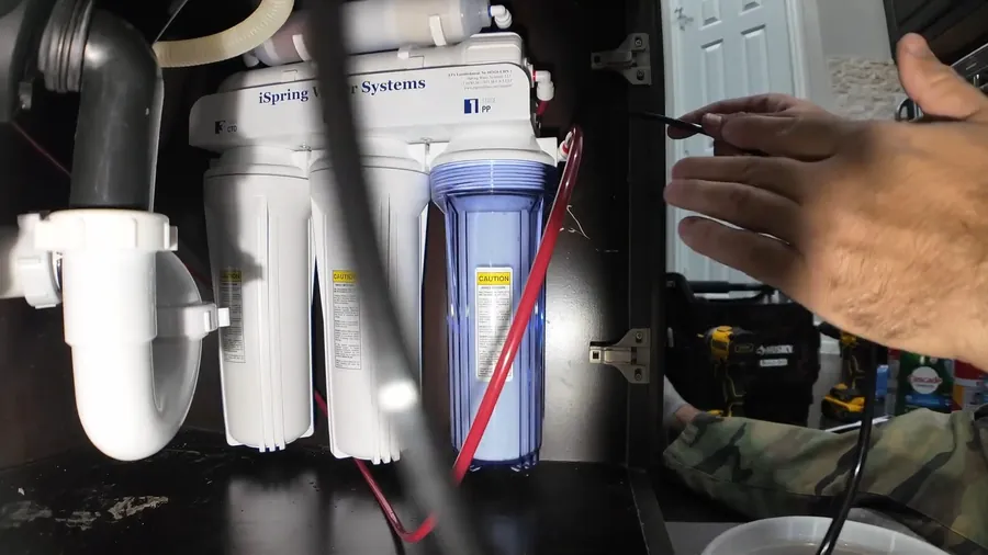 Under-sink reverse osmosis filters with blue supply tubing for Water Filtration Installation in Lakewood, CA