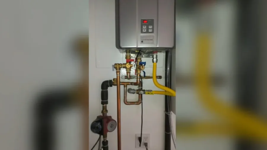 Wall-mounted tankless water heater with gas connections for Water Heater Installation & Replacement in Lakewood, CA