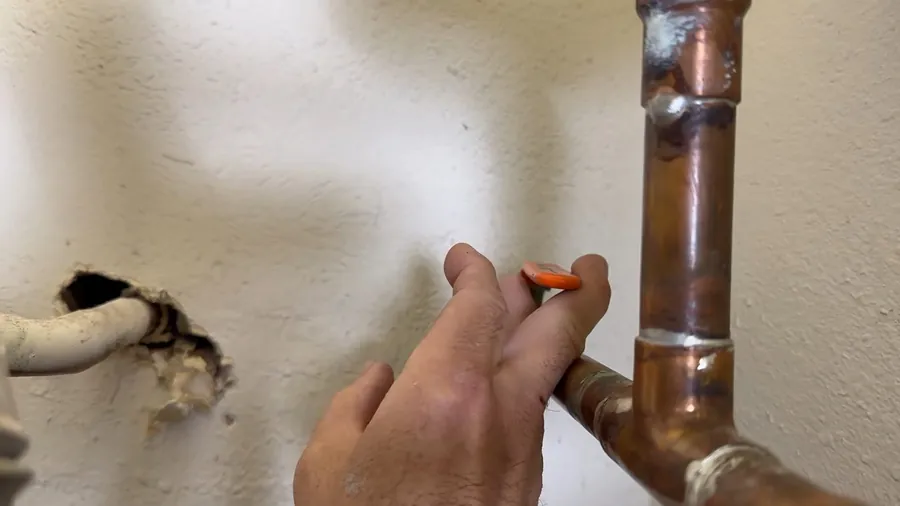Water heater connection with a visible leak at the wall for 24/7 Emergency Plumber in Lakewood, CA