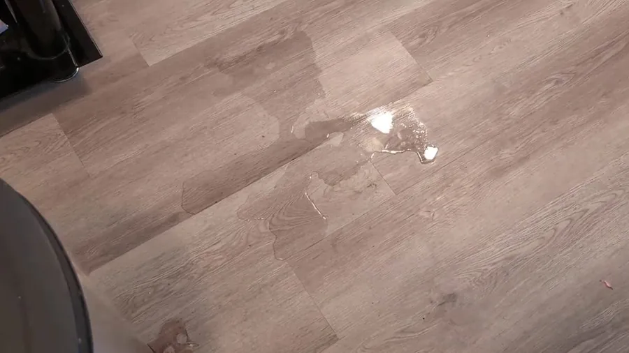 Water puddle on a finished floor from a slab leak for Slab Leak Detection & Repair in Lakewood, CA