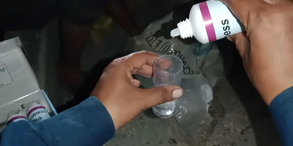 Water test solution being mixed in a small bottle for Lakewood CA Water Quality: Hard Well Water and What It Does to Your Plumbing