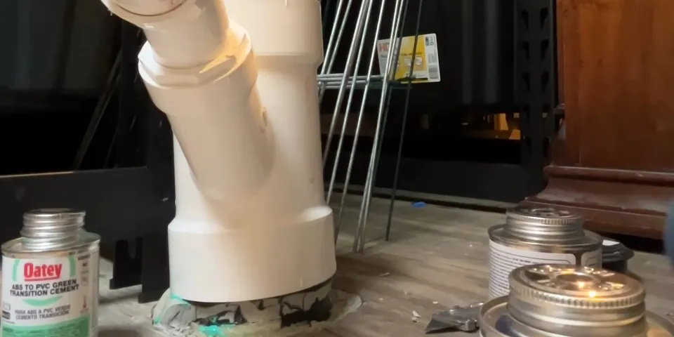 White garbage disposal drain elbow being assembled for Garbage Disposal Repair & Installation in Lakewood, CA