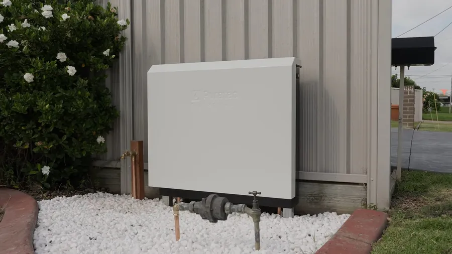 Whole home filtration cabinet mounted on an exterior wall for Water Filtration Installation in Lakewood, CA