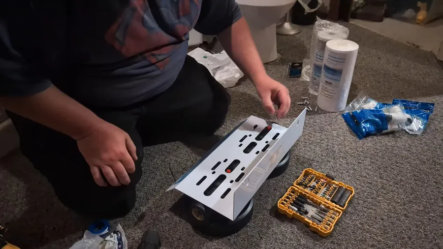 Whole house filtration kit and installation parts on the floor for Slab Leak Repair vs. Whole-Home Repipe: How Lakewood Homeowners Decide